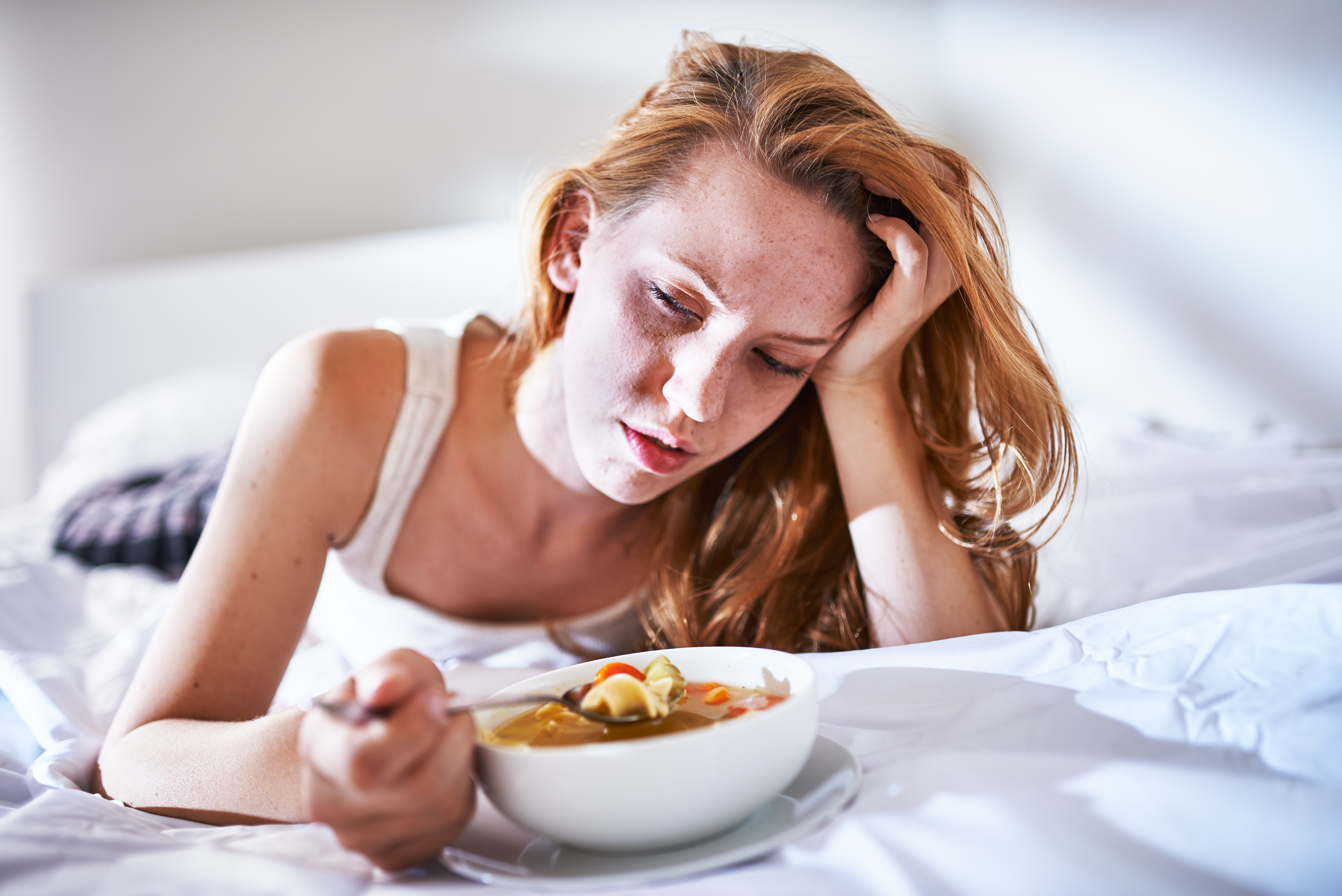 woman tired and sick eating foods with lectins